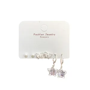 Three-piece silver earring set featuring pearls, hollow butterflies, and star charms