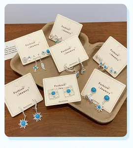 Detailed set of bohemian silver earrings featuring blue stones and tribal sun patterns