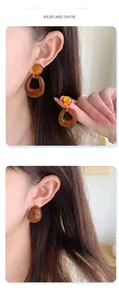 Detail view of amber resin earrings featuring irregular drop and round stud designs