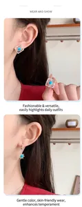 Close-up of bohemian blue gemstone sunburst earrings on model with silver finish