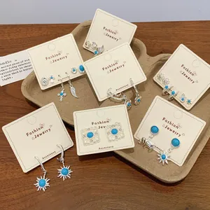 Bohemian silver stud earring set with blue turquoise sunburst and ethnic charms