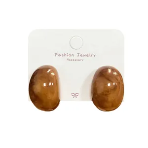 Vintage amber resin hoop earrings for women with tortoiseshell marble texture on card