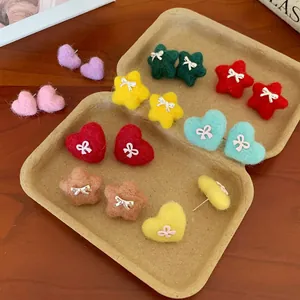 Colorful plush heart and star stud earrings with bow detail for festive winter style