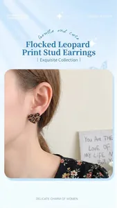Close-up of heart-shaped leopard print flocking earrings on a model for autumn style