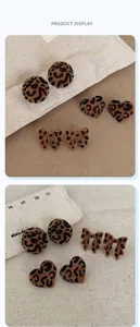 Detail of leopard print flocking earrings in heart, round and bow shapes for autumn style
