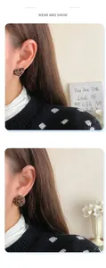 Detail of leopard print heart and round stud earrings with velvet texture for women