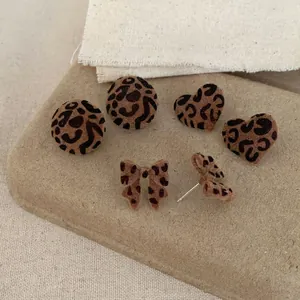 Leopard print flocked heart and round stud earrings with bow details in autumn style