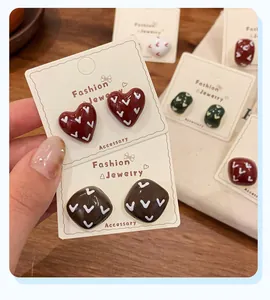 Detail of vintage heart and square stud earrings with colorful oil drip enamel finish
