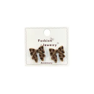 Leopard print flocked bow stud earrings with vintage texture on white display card