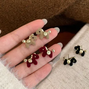 Festive red and khaki flocked dog earrings with gold metal accents for the lunar new year