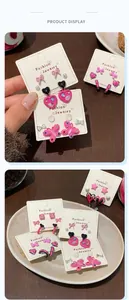 Pink and black butterfly heart earring set displayed on a fashion jewelry card