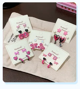 Pink and black butterfly bow earring set displayed on jewelry cards with a star and heart