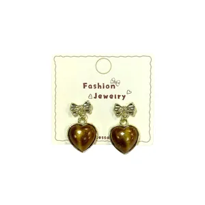 French vintage heart earrings with golden bow and tiger eye brown stone on display card