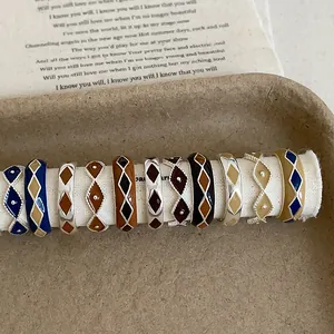 Detailed set of 10 vintage enamel rings with diamond patterns on retro lyric background