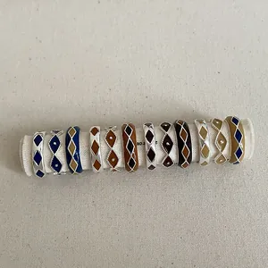 Retro diamond pattern enamel rings in colorful geometric designs on a textured scroll