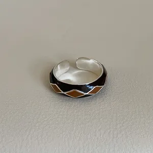 Detailed close-up of retro diamond grid enamel pattern on adjustable silver open ring