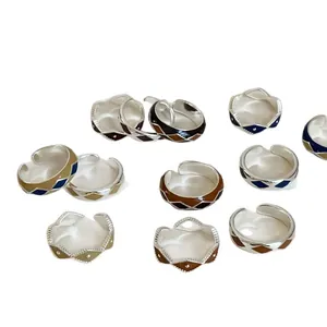 Vintage checkered enamel rings set with geometric diamond patterns and silver metal finish