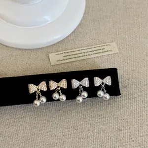 Elegante strik oorbellen met zirkonia en parels in goud en zilver uitvoering