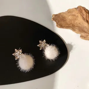 Winter snowflake drop earrings with fluffy beige pom poms and gold accents