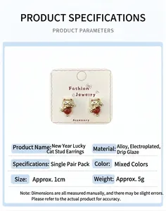 Detail of red Chinese lucky cat earrings with golden finish on a display card
