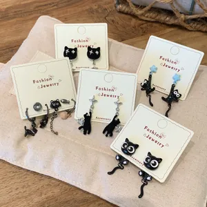 Black cat star earrings set with 5 pairs of asymmetric enamel studs and silver needles