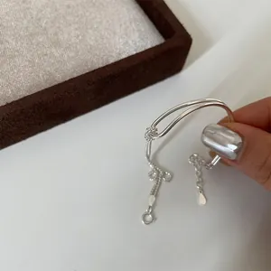 Detail of silver double-strand bracelet featuring adjustable slide bead and lobster clasp
