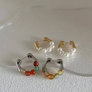 Minimalist gold pearl earrings and colorful agate bead studs in hoop design for women
