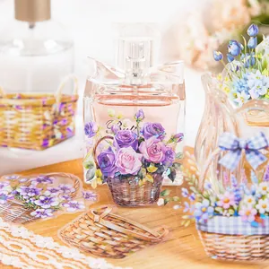 Purple and blue floral PET stickers for DIY scrapbooking displayed on glass perfume bottle