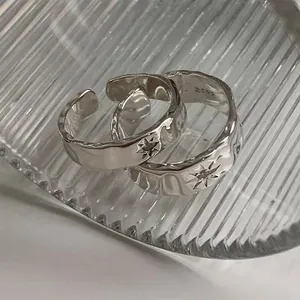 Set of two irregular hammered silver S925 rings with octagonal star patterns