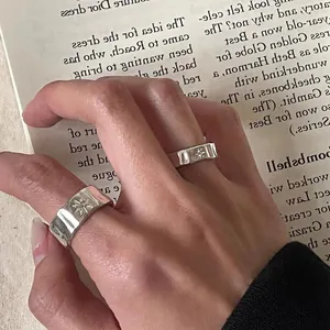 Irregular starburst silver open ring set with vintage matte finish on book background