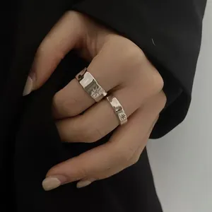Detail of silver irregular starburst rings set with textured metal and star engravings