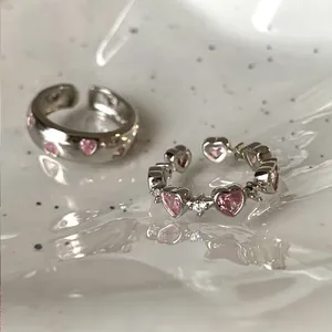 Minimalist open ring set with pink heart-shaped zircons on polished silver-tone metal