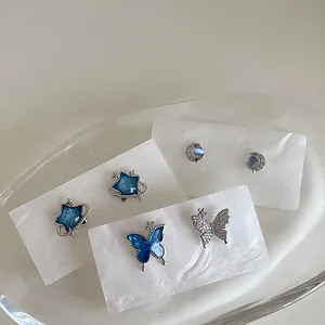 Three-piece set of blue zircon star and butterfly stud earrings in silver finish