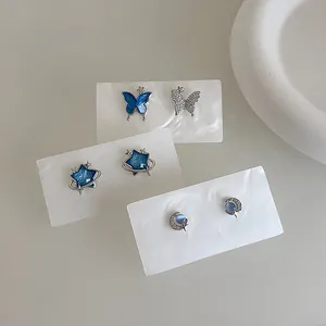 Minimalist blue zircon butterfly and planet stud earrings set with silver finish