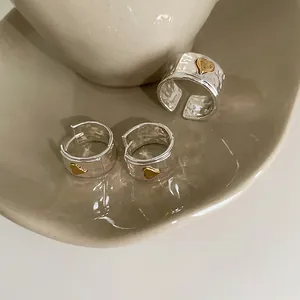Irregular textured silver ring and earrings set with small golden heart motifs