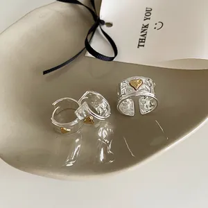 Hammered silver jewelry set with golden hearts featuring an adjustable ring and hoop earrings
