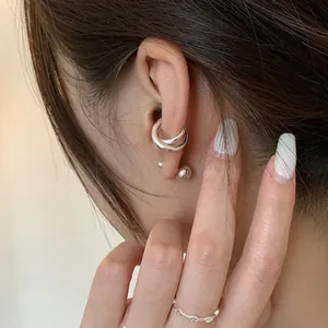 Irregular double-layer ear cuff and silver anchor chain ring on female model