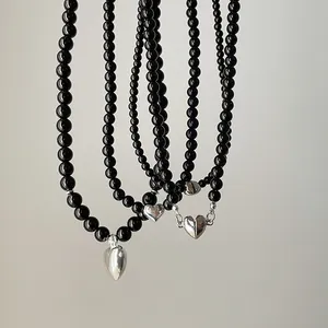 Black beaded necklace with magnetic silver heart pendants for couples and friends