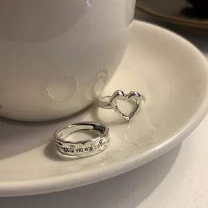 Detailed shot of S925 silver adjustable rings with heart shape and engraved lava texture