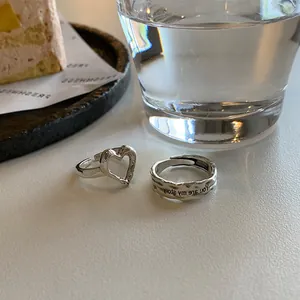 Detailed shot of silver heart ring and engraved band with 'You are my story' text