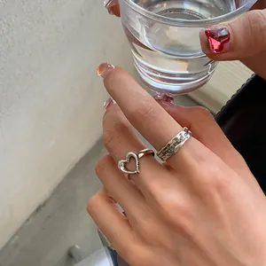 Detailed view of irregular metal rings set with heart shape and You are my star engraving