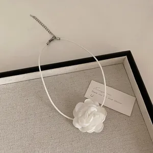 Detail view of the elegant 3D white lace camellia flower choker with adjustable chain