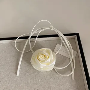 Close-up of cream satin 3D rose choker with elegant long ties on a soft background