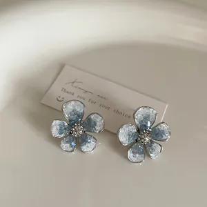 Blue gradient crystal flower stud earrings with silver plating and white rhinestones