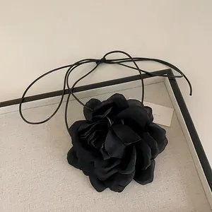 Detailed view of handmade black lace flower choker with elegant fabric petals and long ties