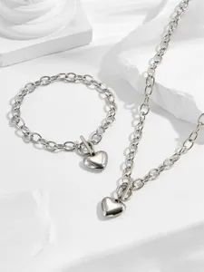 Close-up of polished heart pendant necklace and bracelet set with toggle OT clasp
