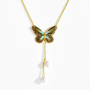 Elegant gold butterfly pendant necklace with blue enamel wings and double white pearls
