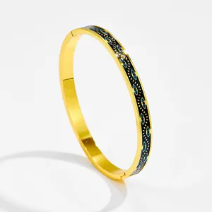 Bracciale rigido in acciaio inossidabile dorato con motivi evil eye in smalto blu