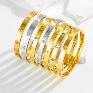 Star-patterned gold and silver bangles with sparkling zircon pavé in high-polish finish