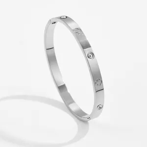 Detail of silver clover engraved bangle with embedded round rhinestones and side hinge